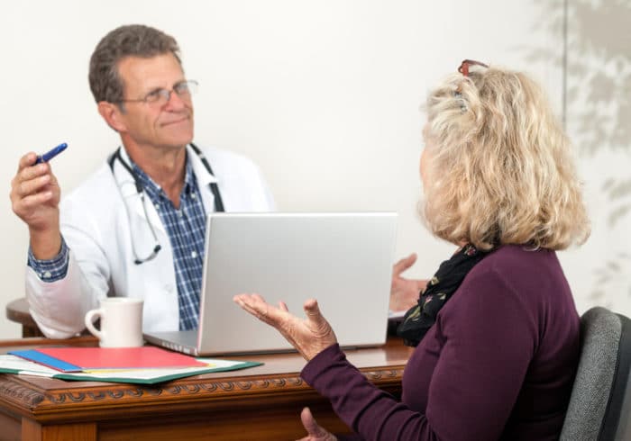 Male Doctor and Female Patient Discuss Insomnia Treatments