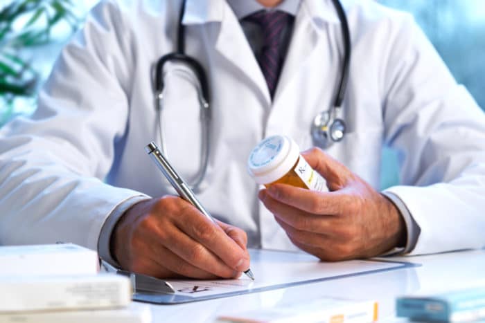 doctor writing a drug prescription for insomnia treatment