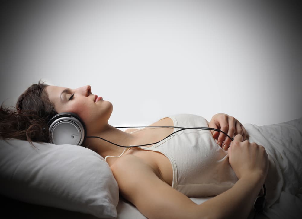 women listening to music in bed