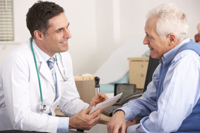 If you’re worried about arthritis and snoring, see a sleep doctor photo of man talking to sleep doctor about arthritis and snoring