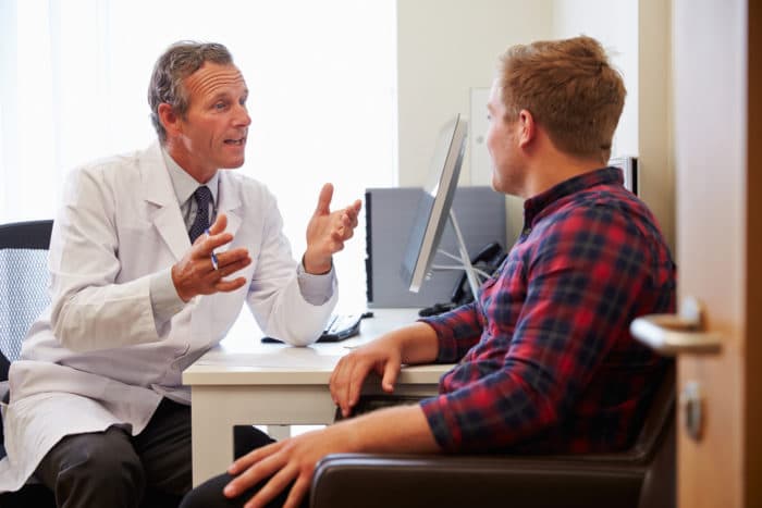 man who can't afford a sleep study talking with doctor