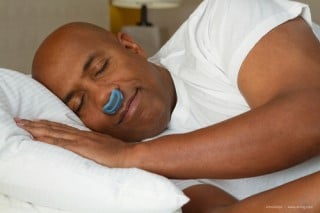 man sleeping with a micro cpap, an innovative new sleep apnea device