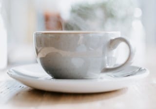 photo of cup holding steaming milk