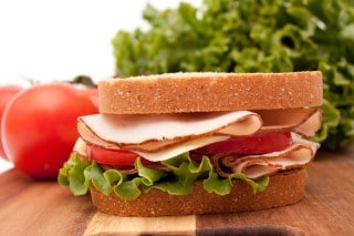 Try eating lighter meals if you find yourself falling asleep at work after lunch photo of a light turkey sandwich for lunch to avoid falling asleep at work