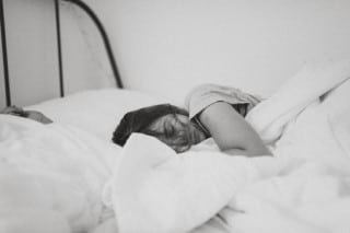Can sleeping too much cause acne? - Maybe teen in bed may wonder if sleeping too much can cause acne