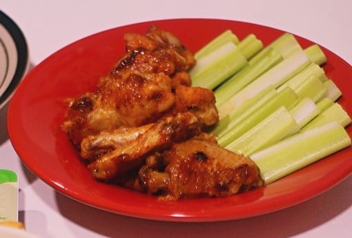 plate with spicy chicken wings which is one of the foods to avoid when having insomnia