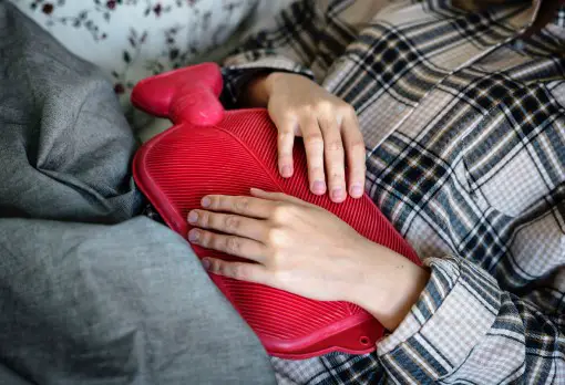 Can sleep help nausea? - Insomnia has been linked to other health issues person laying down with upset stomach wondering if sleep can help nausea