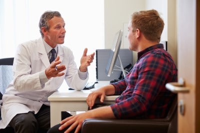 Worried about allergies because you’re sleeping with a fish tank in the bedroom? Talk to your doctor photo of patient talking to doctor at a checkup