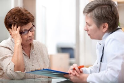 woman talking to doctor about her sleep apnea and pain