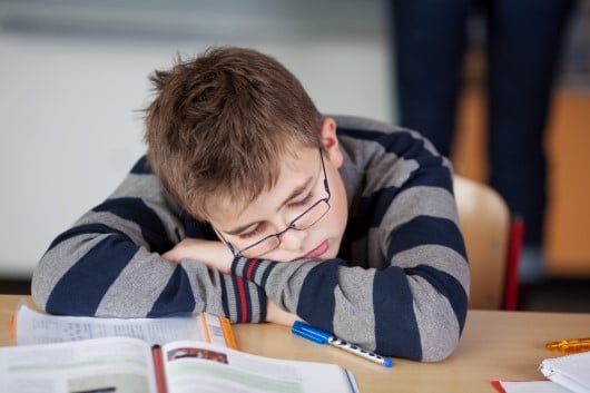 picture of teen asleep in class for which our student sleep resources can help