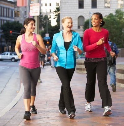 women walking and getting light therapy outside to recover from jet lag