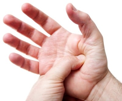 man getting acupressure on his hand to help with jet lab