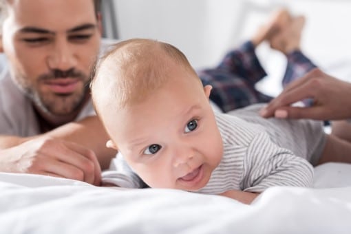 Parents helping baby relax at bedtime