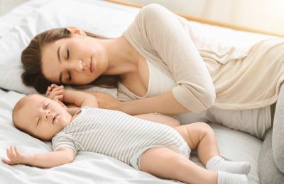women sleeping on her side to prevent snoring after pregnancy