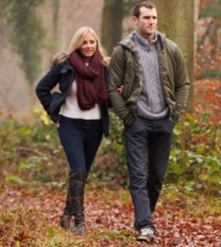 Staying active can help with your nicotine cravings and deep sleep Couple taking a walk in the woods