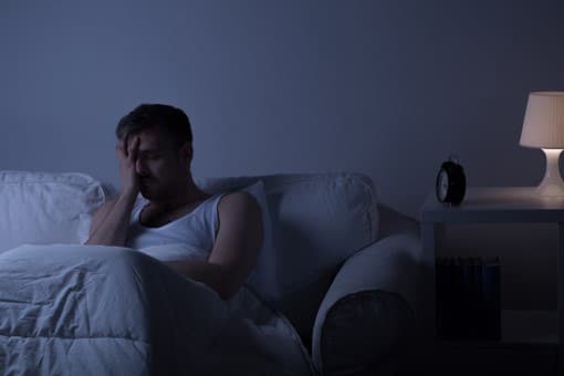 Life is miserable when shoulder pain is keeping you from sleeping on your side picture of miserable man showing what happens if shoulder pain is keeping you from sleeping on your side