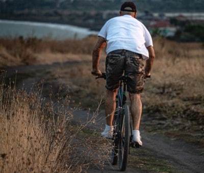 man riding bike for exercise to fight inflammation similar to turmeric for sleep apnea