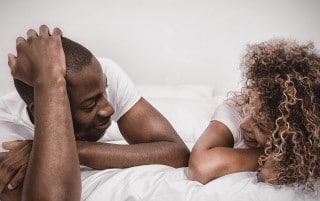 couple wondering what to do when bored in bed at night a bedtime chat