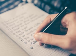 photo of person making a list instead of doing a puzzle before bed