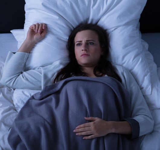 women wide awake wondering what to do when bored in bed at night