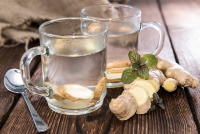 photo of cup of ginger root tea which help fight fatigue so you don't fall asleep