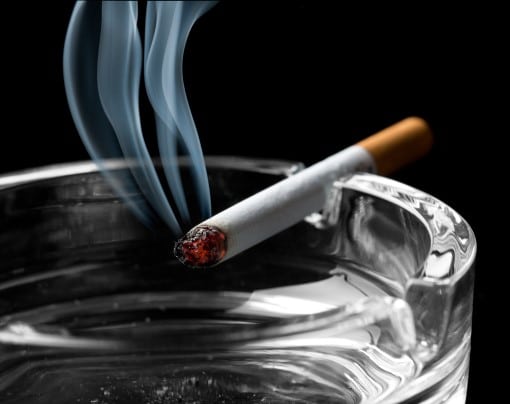 If you’re waking up in the middle of the night to smoke, you’re not the only one cigarette on ashtray from person waking up in the middle of the night to smoke