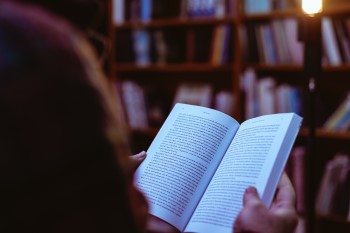 lady reading a book because politics is keeping her awake at night