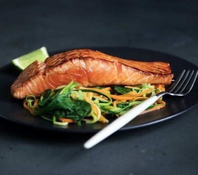 plate salad and salmon showing a healthier meal that can help you treat sleep apnea yourself