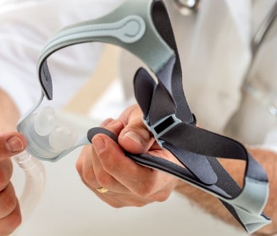 doctor showing adjustments to face mask that can help if CPAP is stressing you out