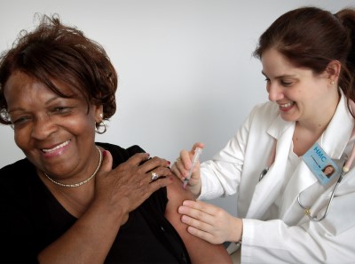 photo of female physician giving a patient an injection to help shoulder pain