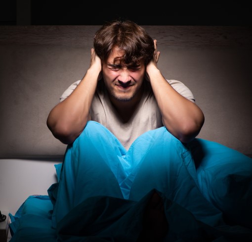 There’s hope if you can't sleep because of noisy neighbors photo of frustrated man who can't sleep because of noisy neighbors
