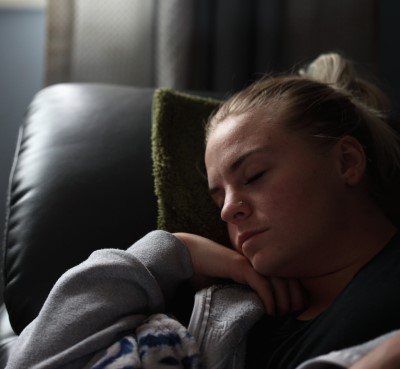 On the worst nights, you might to relocate to a couch in a more quieter spot photo of lady sleeping on couch