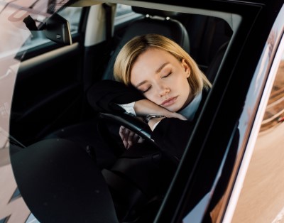 photo of lady napping in car