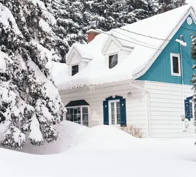 photo of house covered with snow