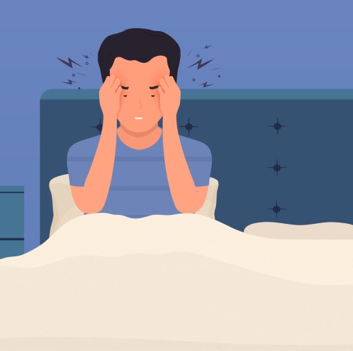 cartoon of man sitting in bed with headache