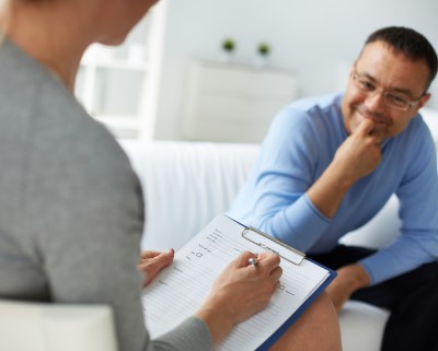 photo of man talking with therapist to help sleep apnea and IBS