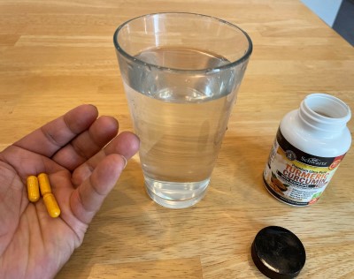 taking tumeric supplement 400px photo of lady sleeping with ear plugs and face mask because spouse keeps the tv on at night