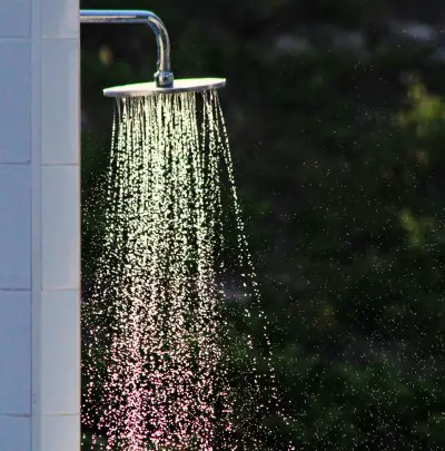 photo of shower running for person who is too hot to sleep after exercise