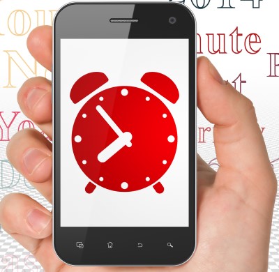 A wakeup phone app is worth a try if you slept through your alarm for work photo of person holding phone with special app which may help if you slept through your alarm for work