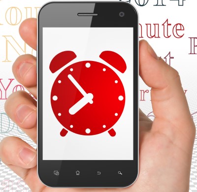 photo of person holding phone with special app which may help if you slept through your alarm for work