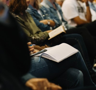 photo of people following along in bible which can help you stay awake at church