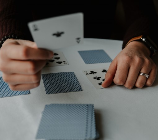 photo of person playing cards which is an example of a fun thing to do before bed