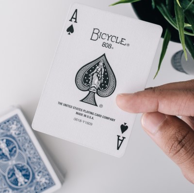  photo of person playing cards as a fun thing to do before bed