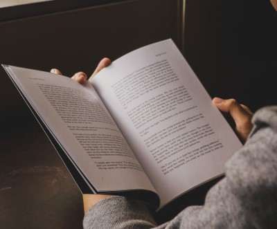 photo of person reading a book as a fun thing to do before bed