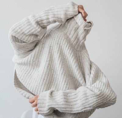 photo of person removing sweater