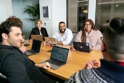 photo of professional in meeting talking to coworkers