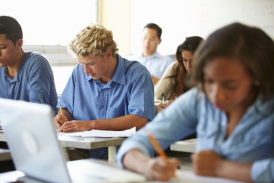 Photo of student too stressed about grades to sleep struggling with a test