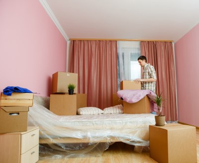 photo of man who can’t sleep after moving unpacking bed room decorations