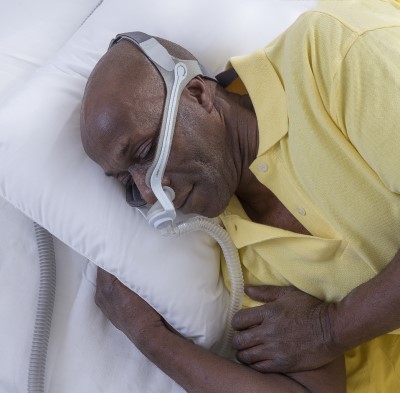 For CPAP users struggling with allergies sleeping on your side might help photo of CPAP user sleeping on side to help allergies