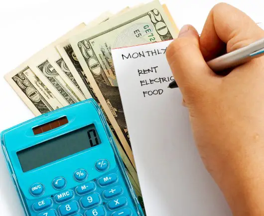 Get on a budget if you’re worried about gas prices and can’t sleep photo showing person budgeting because they’re worried about gas prices going up and can’t sleep